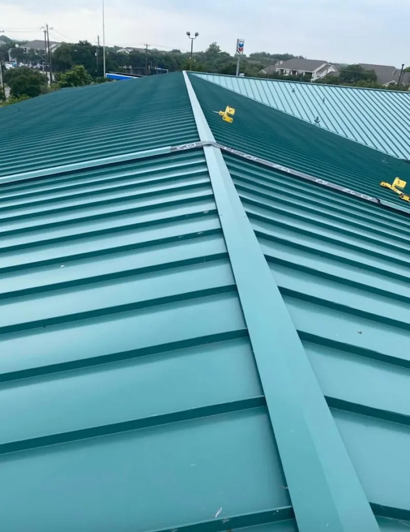 Green commercial metal roof ridge and valley for Metal Roof Repair in Timberwood Park